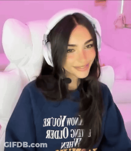 A Woman Wearing Headphones And A Blue Sweatshirt With The Word Order On It . GIF