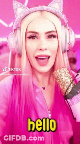 A Woman Wearing Headphones And A Cat Ear Headband Says Hello . GIF