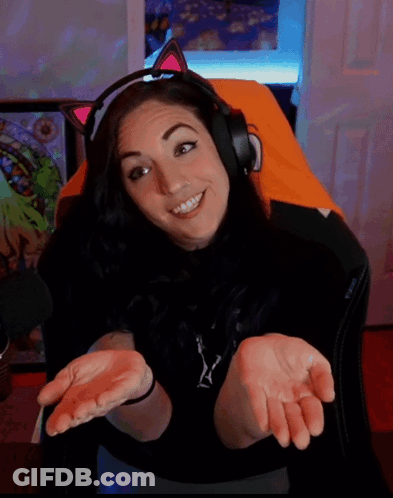 A Woman Wearing Headphones And A Cat Ear Headband Smiles GIF