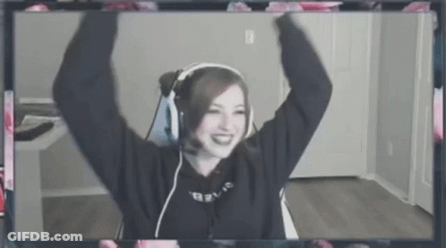 A Woman Wearing Headphones And A Microphone Is Sitting In Front Of A Computer Screen . GIF