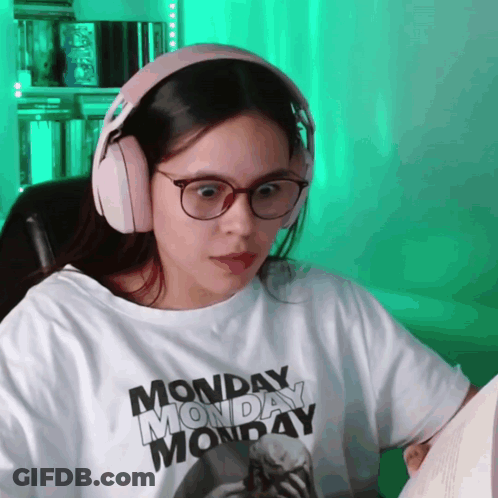 A Woman Wearing Headphones And A Monday Monday T-Shirt GIF