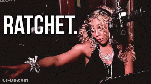 A Woman Wearing Headphones And A Necklace Is Standing In Front Of A Microphone And Says Ratchet . GIF