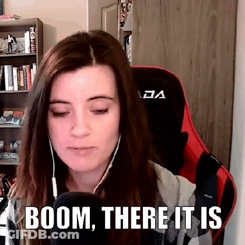 A Woman Wearing Headphones And A Red Chair Is Sitting In Front Of A Microphone With The Words Boom , There It Is . GIF