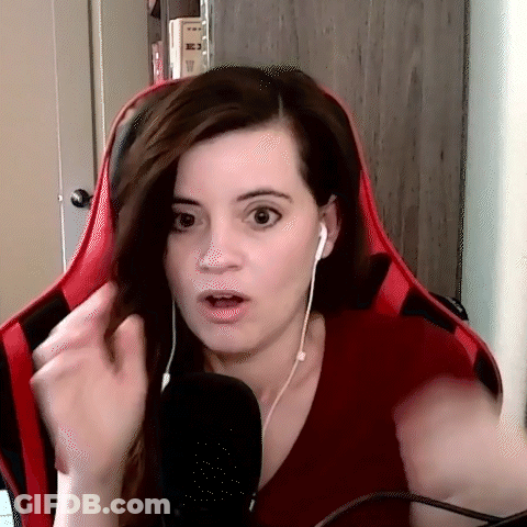 A Woman Wearing Headphones And A Red Shirt Is Sitting In Front Of A Microphone And Making A Funny Face . GIF