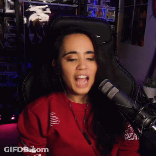 A Woman Wearing Headphones And A Red Sweatshirt With The Word Rt On The Sleeve GIF