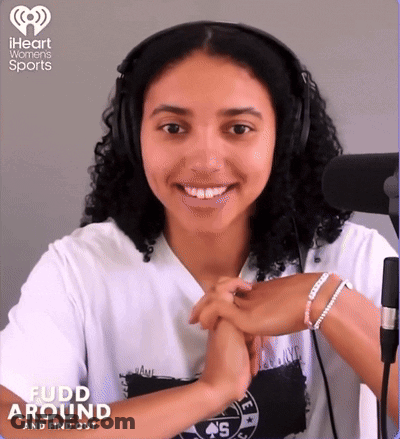 A Woman Wearing Headphones And A Shirt That Says ' Fudd Around ' On It GIF