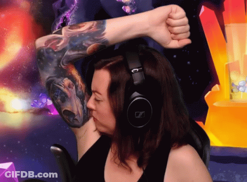A Woman Wearing Headphones And A Tattoo On Her Arm GIF
