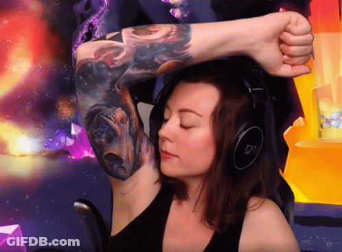A Woman Wearing Headphones And A Tattoo On Her Arm GIF