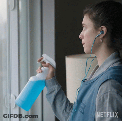 A Woman Wearing Headphones And A Vest That Says Netflix GIF