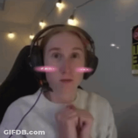 A Woman Wearing Headphones And A White Shirt Is Smiling GIF