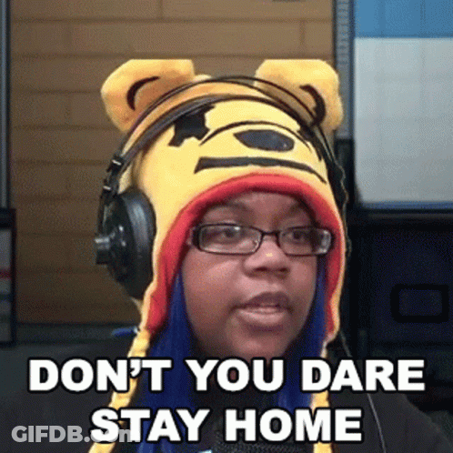 A Woman Wearing Headphones And A Winnie The Pooh Hat Says " Don T You Dare Stay Home " GIF
