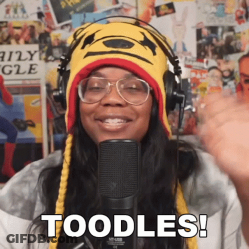 A Woman Wearing Headphones And A Winnie The Pooh Hat Says " Toodles " In Front Of A Microphone GIF