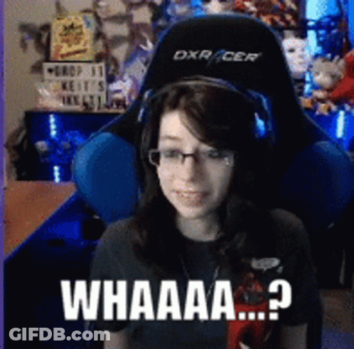 A Woman Wearing Headphones And Glasses Is Sitting In A Gaming Chair With The Words Whaaa Written On The Bottom GIF