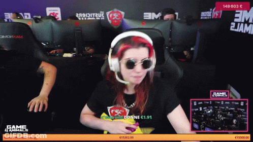 A Woman Wearing Headphones And Sunglasses Is Sitting In Front Of A Computer Screen That Says Game 4 Animals GIF