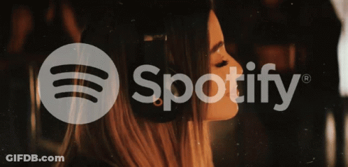 A Woman Wearing Headphones And The Spotify Logo GIF