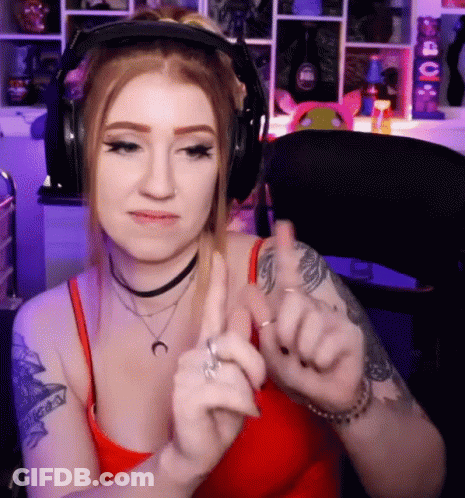A Woman Wearing Headphones Giving A Thumbs Up Sign GIF