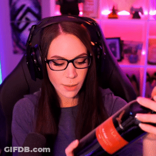 A Woman Wearing Headphones Holds A Bottle Of Wine GIF