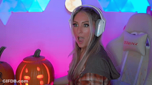 A Woman Wearing Headphones Holds A Carved Pumpkin GIF