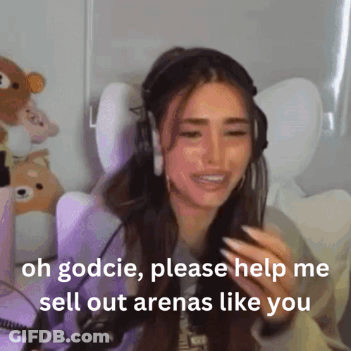 A Woman Wearing Headphones Is Crying And Asking For Help To Sell Out Arenas Like You GIF