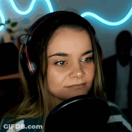 A Woman Wearing Headphones Is Looking At A Microphone . GIF