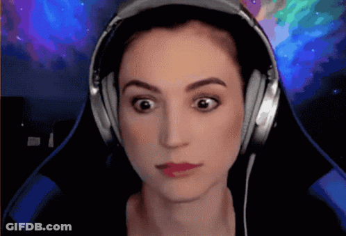 A Woman Wearing Headphones Is Making A Funny Face GIF
