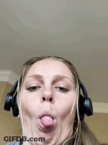 A Woman Wearing Headphones Is Making A Funny Face GIF