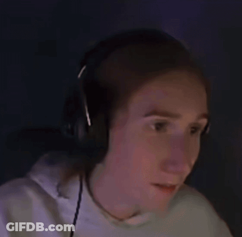 A Woman Wearing Headphones Is Making A Surprised Face While Playing A Video Game . GIF
