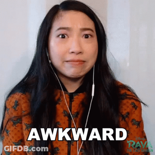 A Woman Wearing Headphones Is Making An Awkward Face While Looking At The Camera . GIF