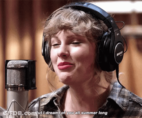 A Woman Wearing Headphones Is Singing Into A Microphone And Says " But I Dreamt Of You All Summer Long " GIF