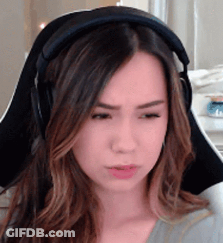 A Woman Wearing Headphones Is Sitting In A Chair And Making A Funny Face . GIF