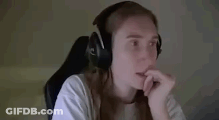A Woman Wearing Headphones Is Sitting In A Chair And Waving Her Hand . GIF