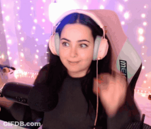 A Woman Wearing Headphones Is Sitting In A Chair That Says Intel On It GIF