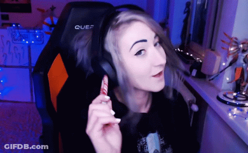 A Woman Wearing Headphones Is Sitting In A Chair That Says Quef On It GIF