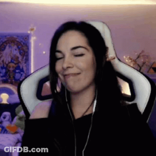 A Woman Wearing Headphones Is Sitting In A Chair With Her Eyes Closed GIF
