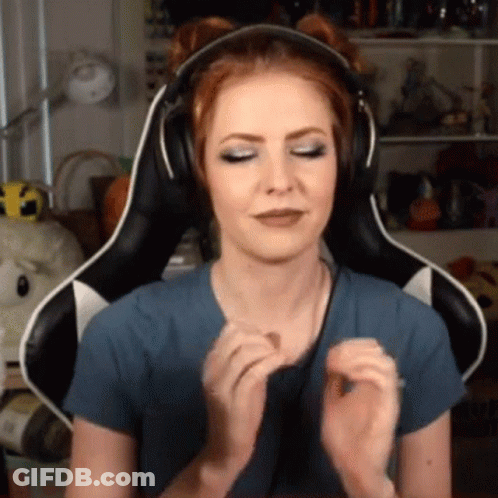 A Woman Wearing Headphones Is Sitting In A Gaming Chair And Making A Face . GIF