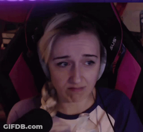 A Woman Wearing Headphones Is Sitting In A Pink Chair And Making A Sad Face . GIF