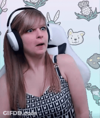 A Woman Wearing Headphones Is Sitting In A White Chair GIF
