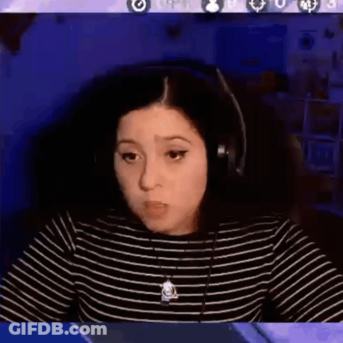 A Woman Wearing Headphones Is Sitting In Front Of A Computer Screen With The Words Ok Cool Written On It . GIF