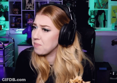 A Woman Wearing Headphones Is Sitting In Front Of A Green Wall GIF
