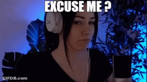 A Woman Wearing Headphones Is Sitting In Front Of A Microphone And Says `` Excuse Me ? '' GIF