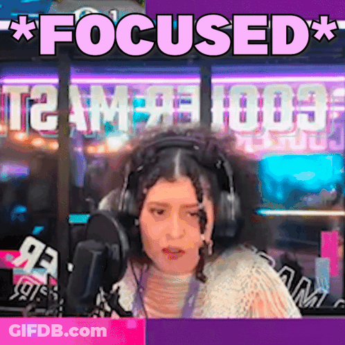 A Woman Wearing Headphones Is Sitting In Front Of A Microphone And The Words Focused Are Above Her GIF