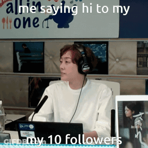 A Woman Wearing Headphones Is Sitting In Front Of A Microphone With The Words " All Me Saying Hi To My 10 Followers " Be GIF