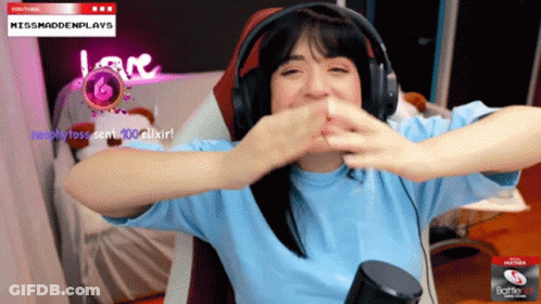 A Woman Wearing Headphones Is Sitting In Front Of A Screen That Says Missmaddenplays On It GIF