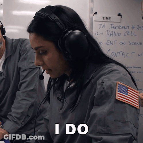 A Woman Wearing Headphones Is Sitting In Front Of A White Board That Says Time GIF
