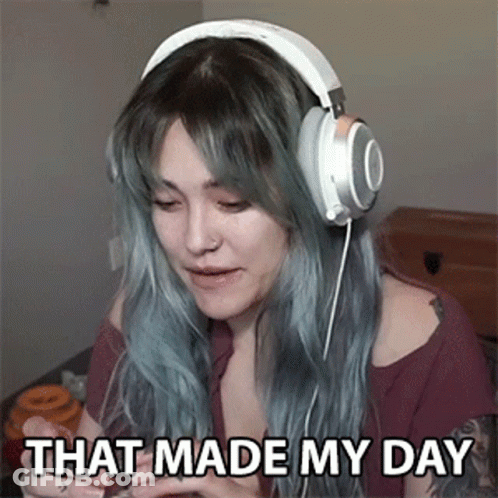 A Woman Wearing Headphones Is Sitting On A Bed And Says `` That Made My Day '' . GIF