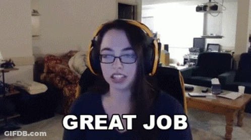 A Woman Wearing Headphones Says " Great Job " In A Living Room GIF