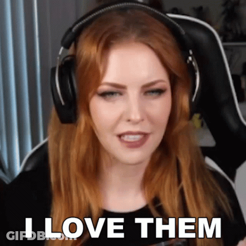 A Woman Wearing Headphones Says " I Love Them " While Sitting In A Chair . GIF