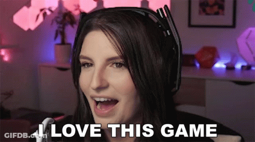A Woman Wearing Headphones Says " I Love This Game " In Front Of A Microphone GIF