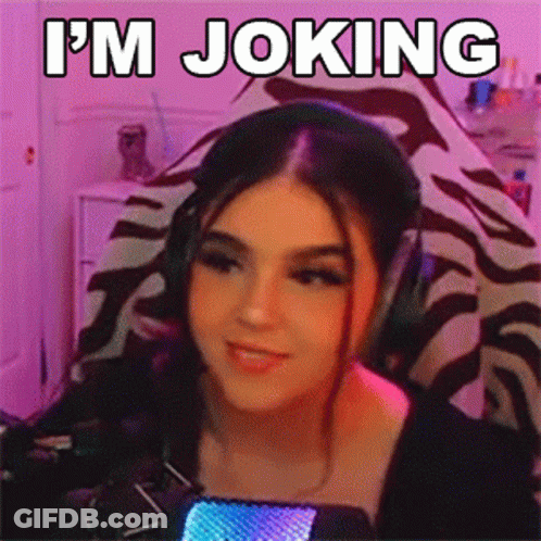 A Woman Wearing Headphones Says I 'M Joking In Front Of A Microphone . GIF