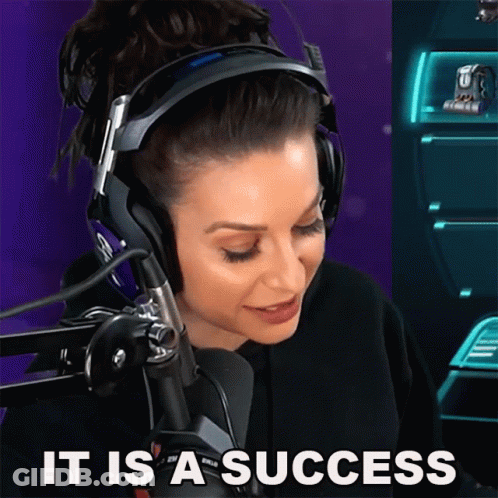 A Woman Wearing Headphones Says " It Is A Success " In Front Of A Microphone GIF